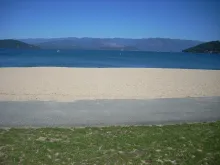 Sandpoint City Beach on Lake Pend Oreille with the Selkirk Mountains across the water.