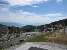 Schweitzer Mountain Resort village with Lake Pend Oreille in the distance.