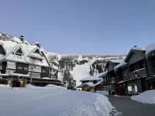 Schweitzer Mountain Resort village covered in snow below the ski slopes.