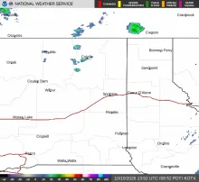 KOTX NEXRAD radar on the morning of October 10, 2026, showing shower activity with echo cells over the Colville highlands and near the Canadian border north of Sandpoint.