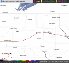 NEXRAD radar image from the Spokane (KOTX) station showing light precipitation echoes over northern Washington with quiet conditions near Sandpoint, Idaho.