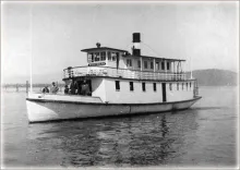 Historic photograph of the double-deck steamer Northern on Lake Pend Oreille with passengers on its stern deck.