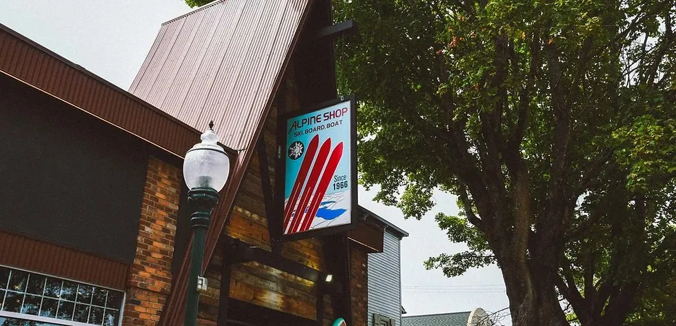 The Alpine Shop exterior in Sandpoint with its Alpine Shop Ski Board Boat sign reading Since 1966.
