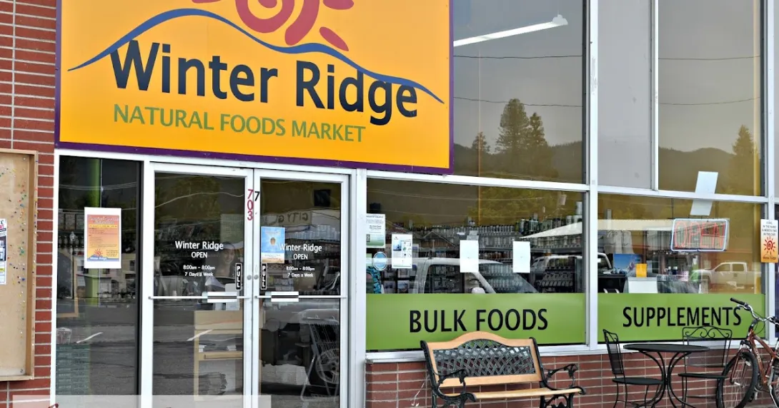 The storefront of Winter Ridge Natural Foods Market in Sandpoint, its yellow sign above windows marked Bulk Foods and Supplements.