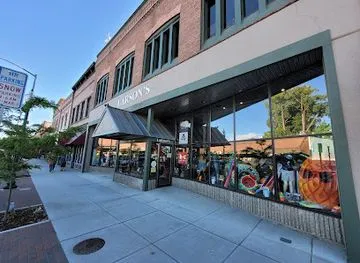 The brick storefront of Larson's Good Clothes on First Avenue in downtown Sandpoint, with its large display windows.