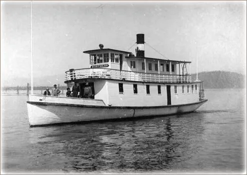 Historic photograph of the double-deck steamer Northern on Lake Pend Oreille with passengers on its stern deck.